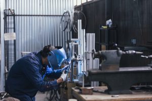 side-view-of-worker-with-welding-machine